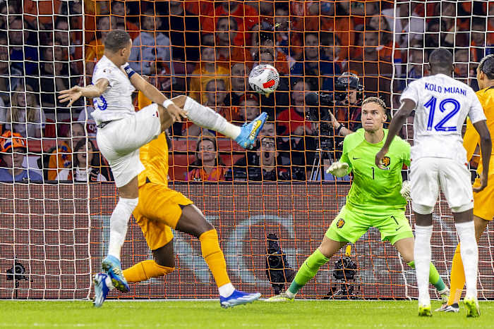 Kylian Mbappe pictured volleying the ball to score his 41st international goal for France during a Euro 2024 qualifier against the Netherlands in October 2023